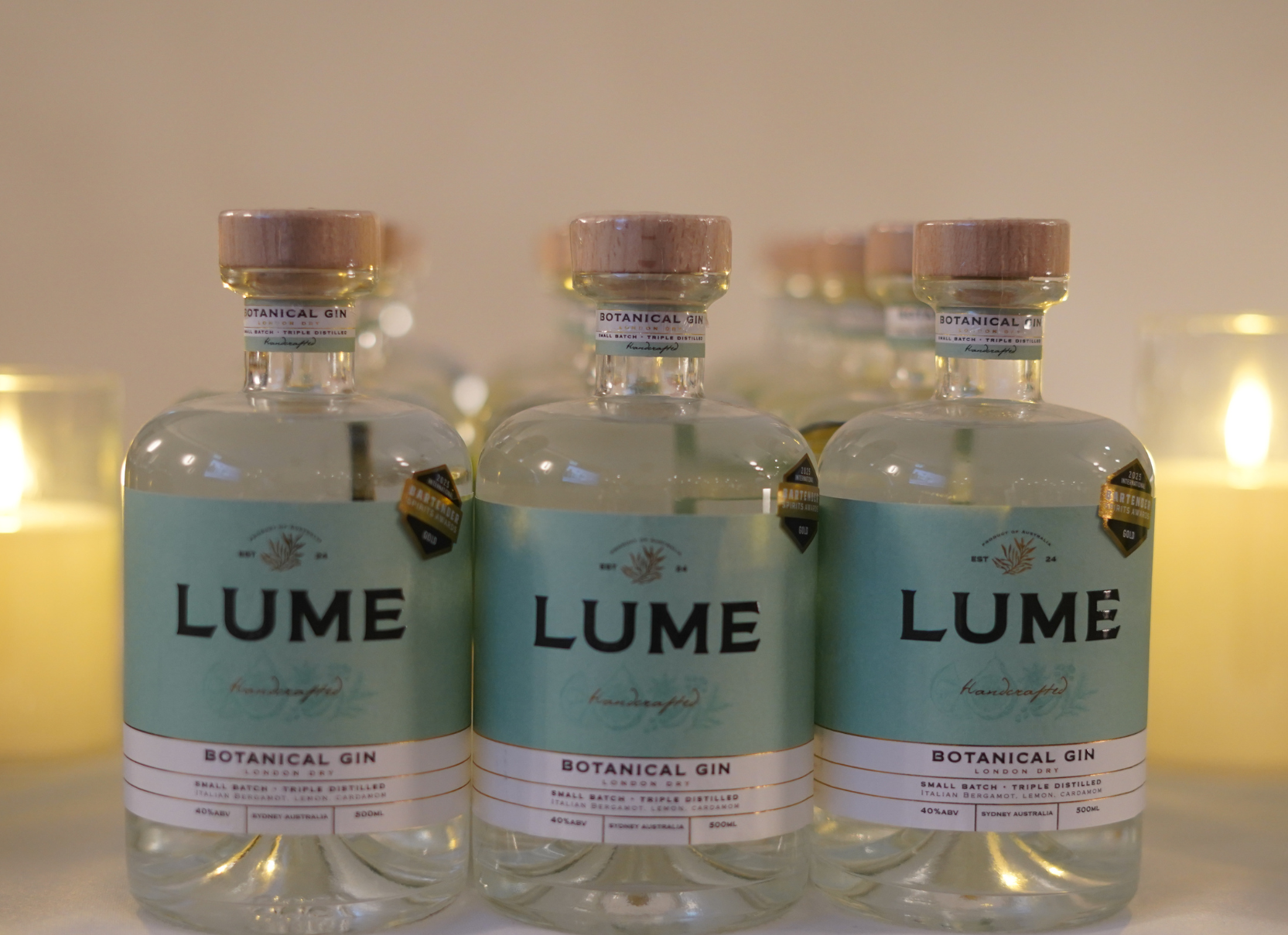 Lume Botanical Gin bottles by candlelight